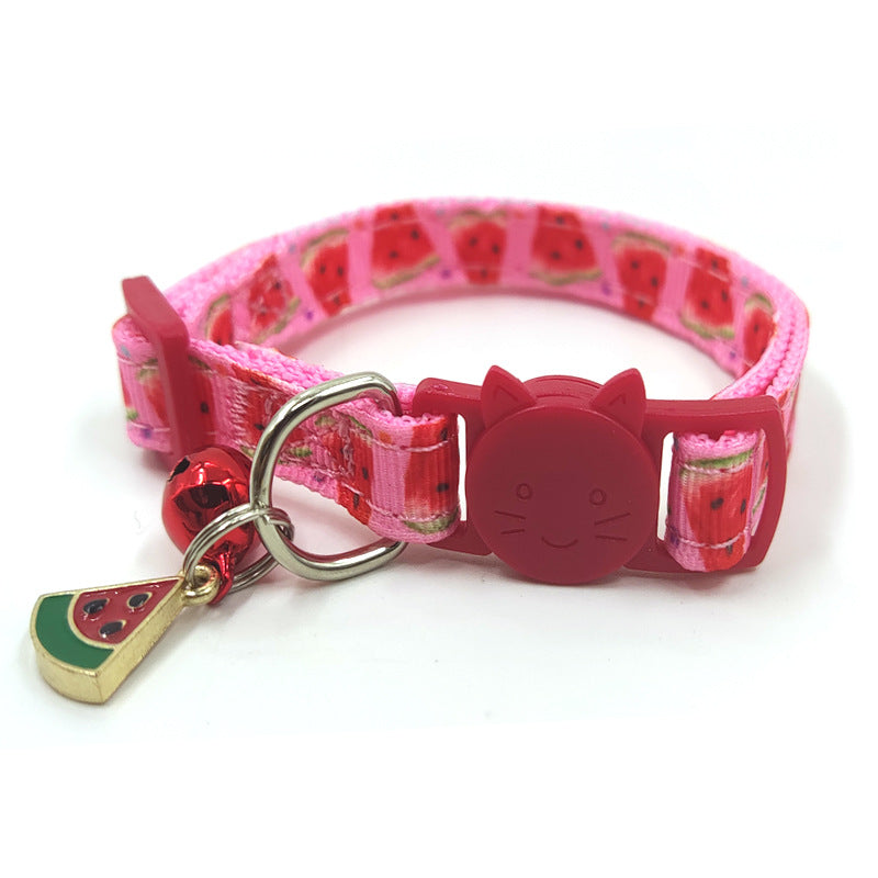 Cat wearing fruit print collar with bell
