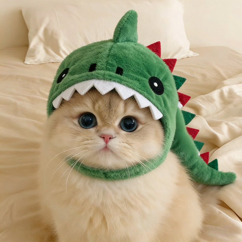 Cat wearing viral dinosaur hood with launcher toy accessory